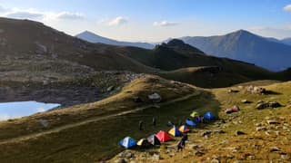 Tents pitched on the meadow above Liqeni i Zemrës, the Heart Lake, in the mountains of Deçan, Bjeshkët e Nemuna