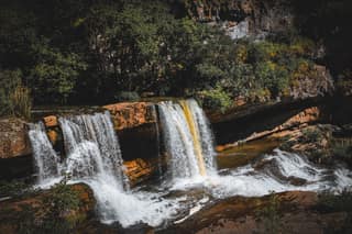 Two of the lower Mirusha falls pouring over a red limestone step into the gorge in spring
