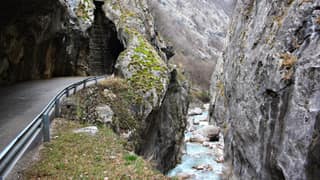 The canyon road hugging the limestone wall of Rugova above the turquoise Lumbardhi torrent