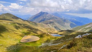 The two tarns known as the Eyes of Sharr on the high pastures above Dragash, with the main ridge beyond