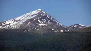 The snow-streaked pyramid of Ljuboten rising above dark forest in the Sharr Mountains
